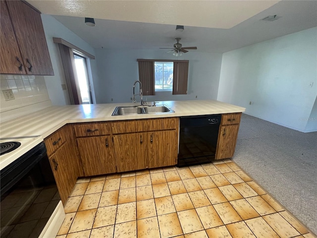 kitchen with ceiling fan, sink, kitchen peninsula, light colored carpet, and black appliances