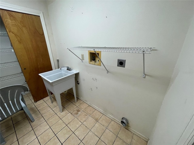 washroom with washer hookup, electric dryer hookup, light tile patterned flooring, and sink