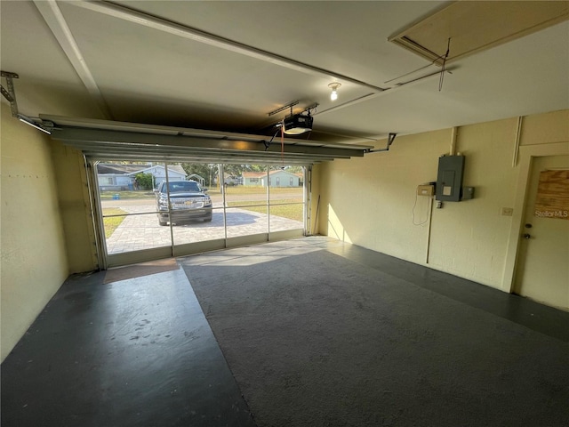 garage featuring electric panel and a garage door opener