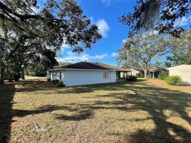 view of side of home with a lawn