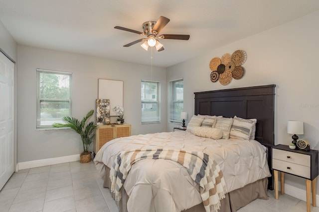 tiled bedroom with a closet and ceiling fan