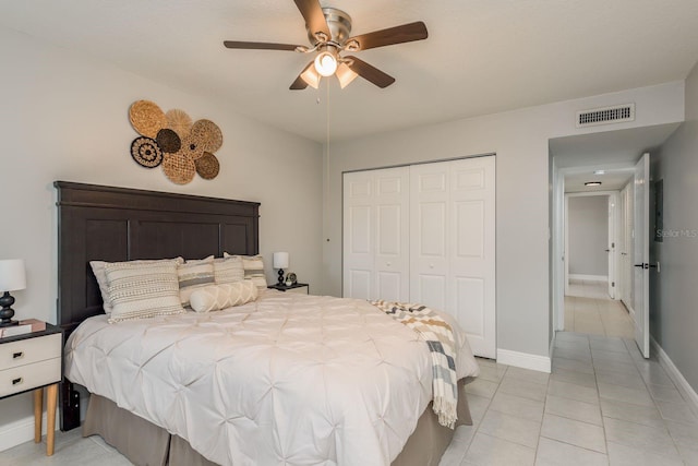 bedroom with ceiling fan, a closet, and light tile patterned flooring