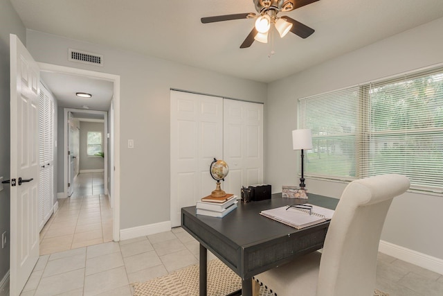 tiled office space with ceiling fan