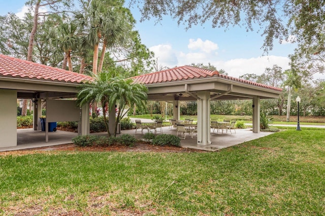 surrounding community with a lawn, a gazebo, and a patio area