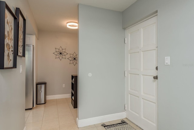 hallway featuring light tile patterned floors