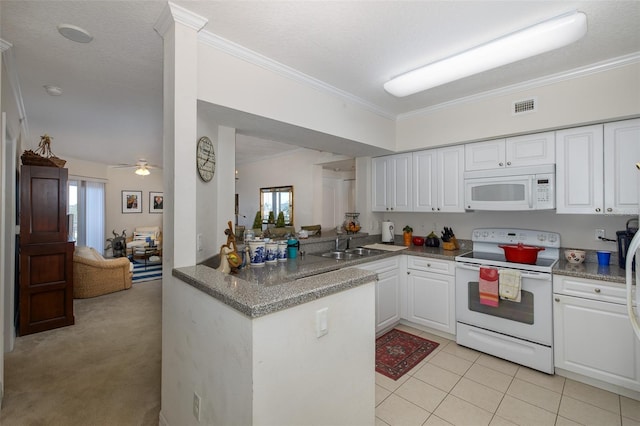 kitchen featuring white appliances, white cabinets, crown molding, ceiling fan, and light colored carpet