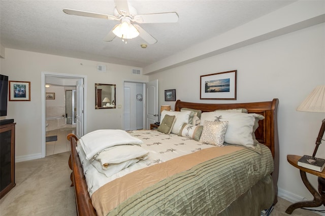 carpeted bedroom featuring a textured ceiling, ceiling fan, and ensuite bathroom