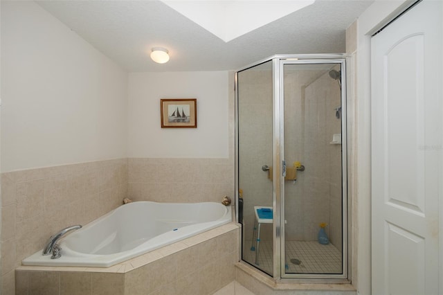 bathroom featuring a textured ceiling and independent shower and bath