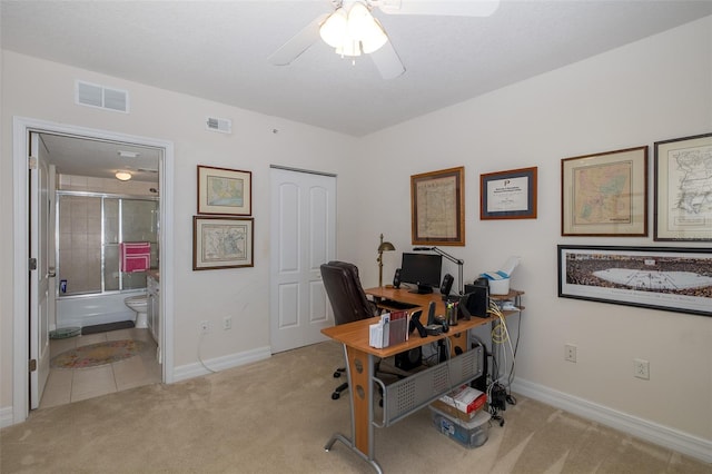 office space featuring light carpet and ceiling fan