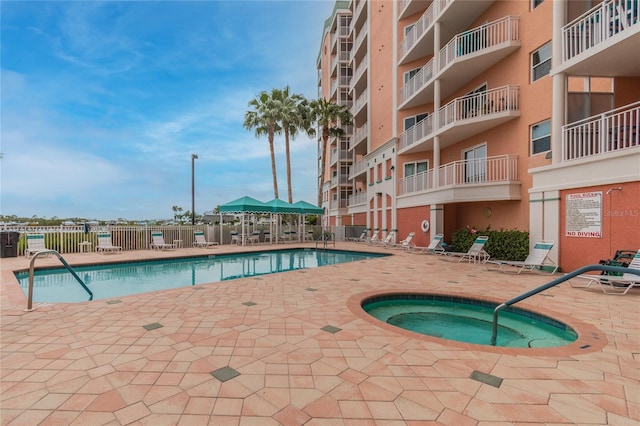 view of pool featuring a patio area and a community hot tub