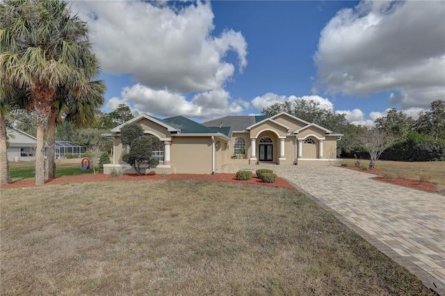 single story home with a garage and a front lawn