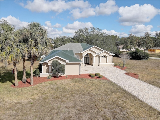 ranch-style house featuring a front yard and a garage