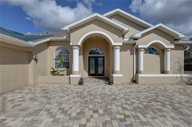 entrance to property featuring french doors and a garage