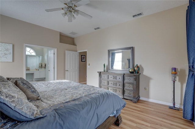 bedroom featuring ensuite bath, ceiling fan, and light wood-type flooring