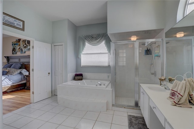 bathroom featuring tile patterned flooring, vanity, and shower with separate bathtub