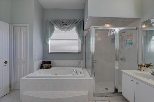 bathroom with tile patterned flooring, vanity, a healthy amount of sunlight, and an enclosed shower