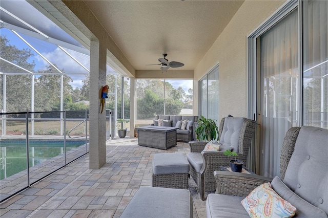 sunroom featuring ceiling fan