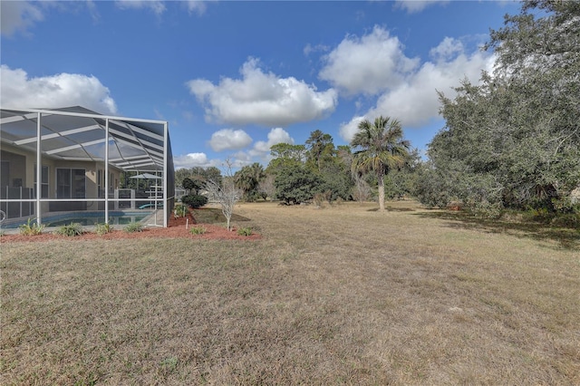 view of yard with glass enclosure