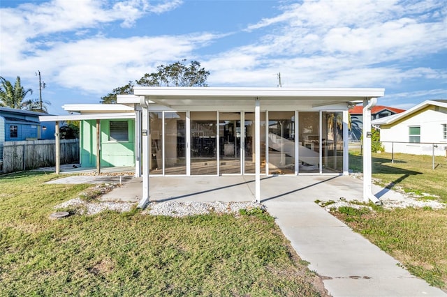 back of property with a lawn and a patio area