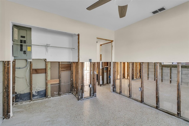 interior space with ceiling fan and electric panel