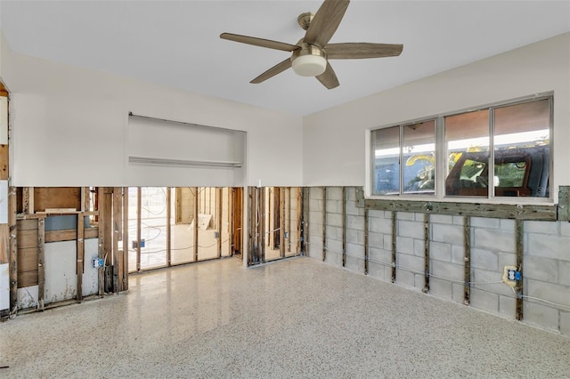 spare room with ceiling fan and a wealth of natural light