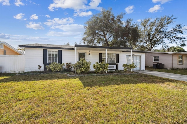 ranch-style home with covered porch and a front yard