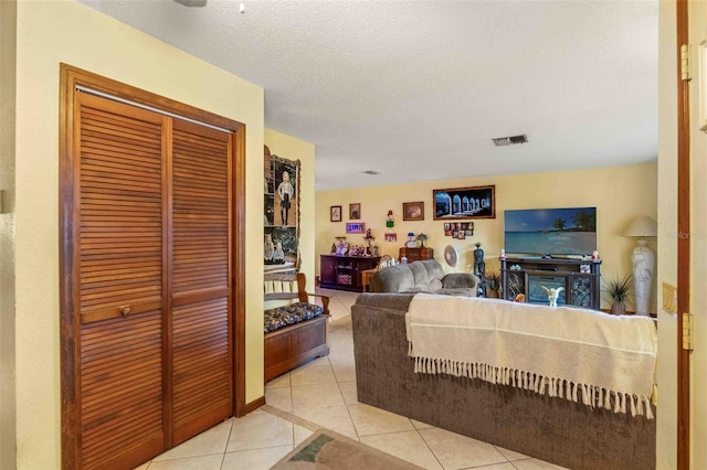 living room with light tile patterned flooring and a textured ceiling