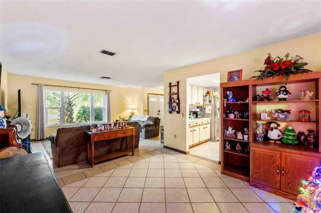 living room featuring light tile patterned floors and a textured ceiling