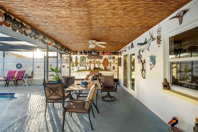 sunroom featuring ceiling fan