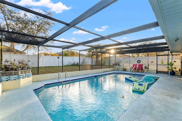 view of swimming pool featuring a patio area and a lanai