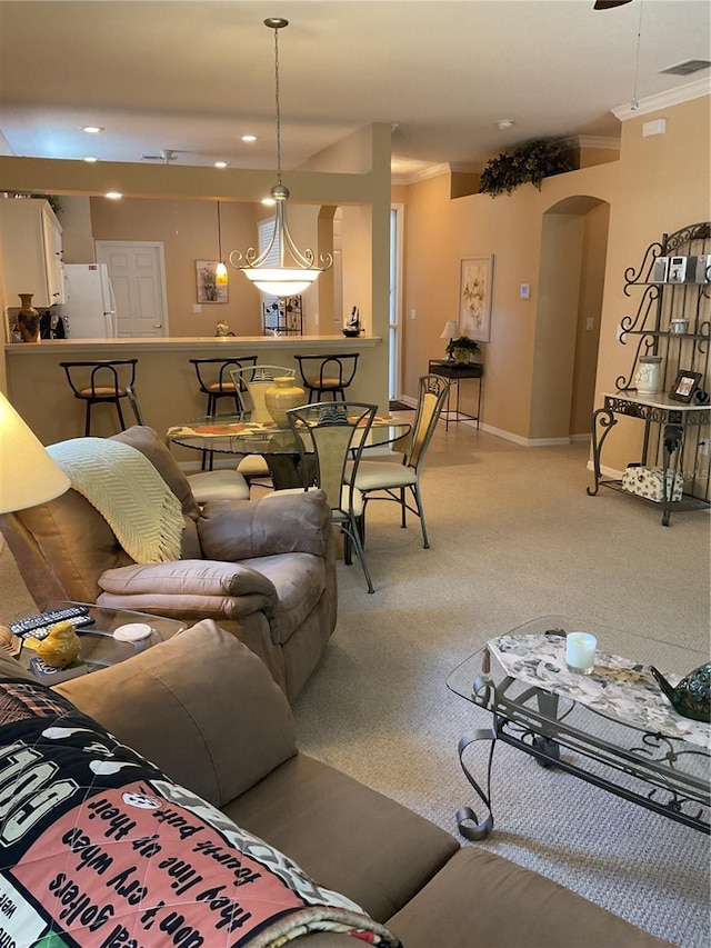 living room with carpet floors and crown molding