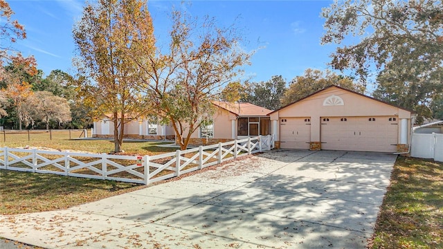 single story home featuring a front yard and a garage