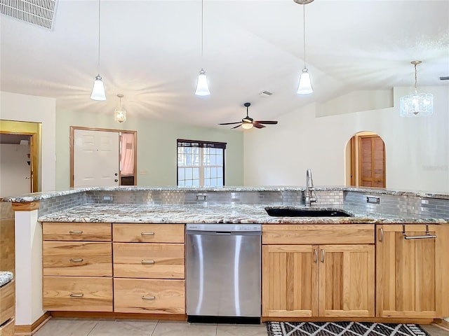 kitchen with ceiling fan, dishwasher, sink, light stone counters, and lofted ceiling