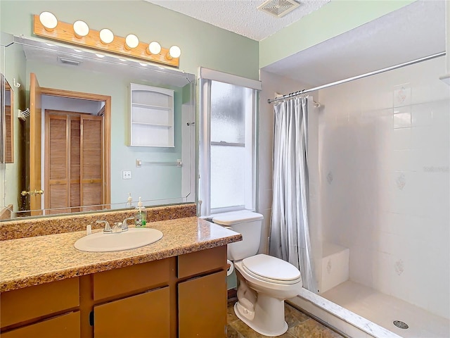 bathroom with a textured ceiling, vanity, toilet, and a shower with curtain