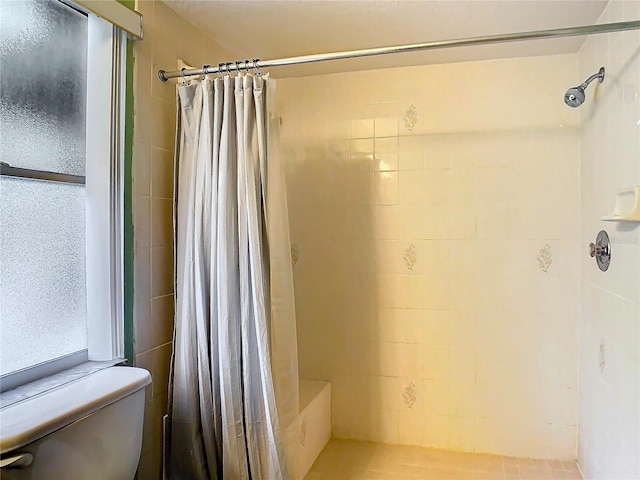 bathroom with a shower with shower curtain and toilet