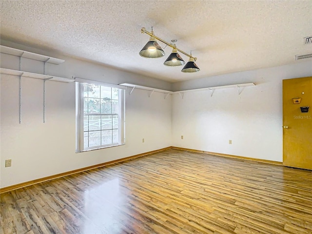 interior space with hardwood / wood-style flooring and a textured ceiling