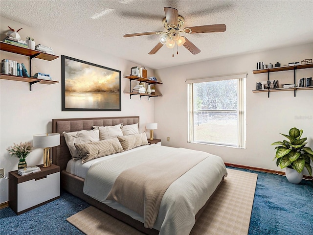 bedroom featuring ceiling fan, carpet floors, and a textured ceiling