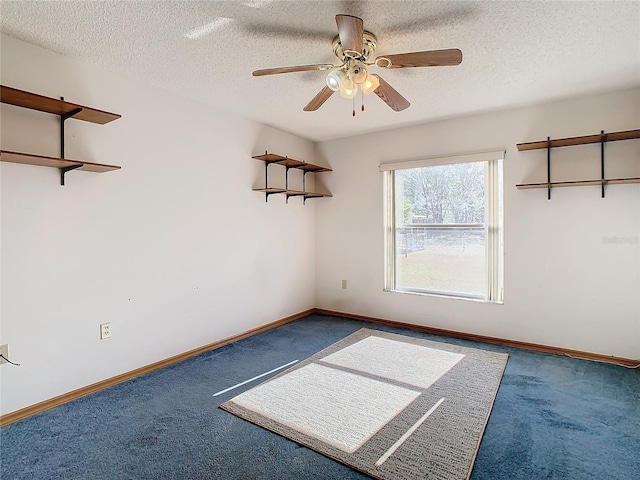 spare room with ceiling fan, carpet floors, and a textured ceiling