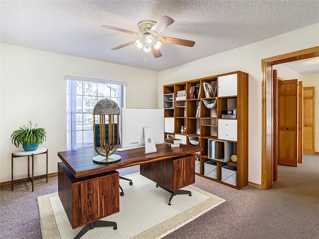 carpeted office with ceiling fan and a textured ceiling