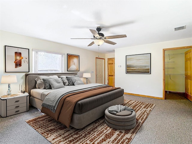 carpeted bedroom with ceiling fan and a closet