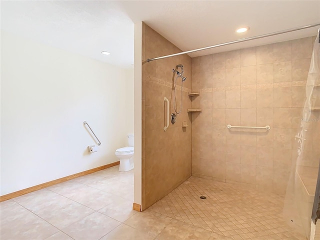 bathroom with tile patterned flooring, toilet, and tiled shower