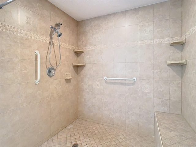 bathroom with a tile shower