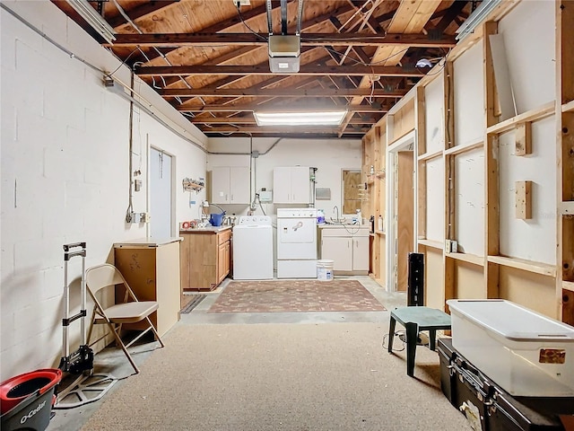 basement featuring washer and clothes dryer and sink