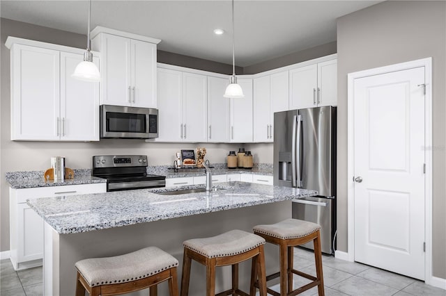 kitchen with white cabinets, an island with sink, and appliances with stainless steel finishes