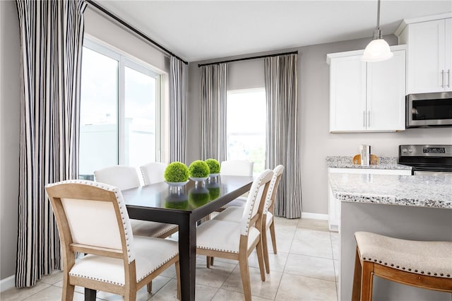 dining room featuring plenty of natural light and light tile patterned flooring