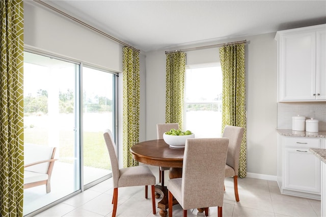 tiled dining area featuring a healthy amount of sunlight