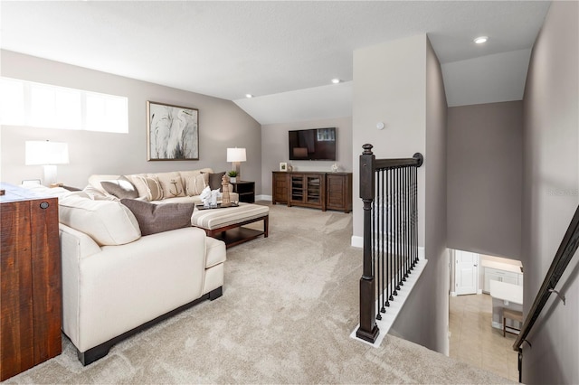 carpeted living room featuring vaulted ceiling