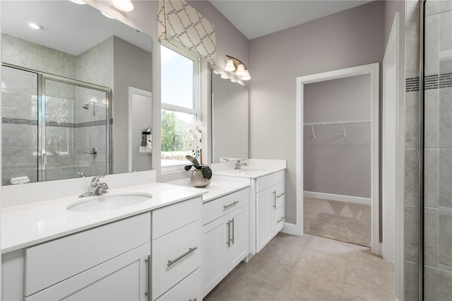 bathroom with vanity, tile patterned floors, and a shower with door