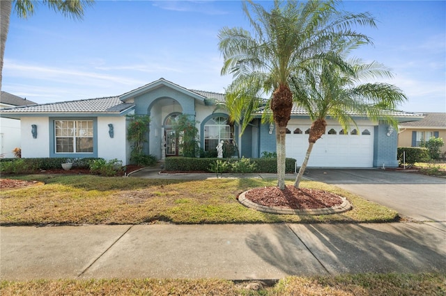 view of front of property featuring a front lawn and a garage