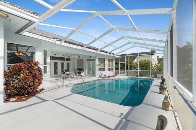 view of pool featuring a lanai, a patio area, ceiling fan, and french doors